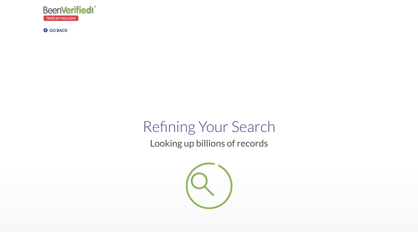 A near-empty BeenVerified funnel screen reading "Refining Your Search" above the line "Looking up billions of records", with a green magnifying-glass spinner and a GO BACK link.